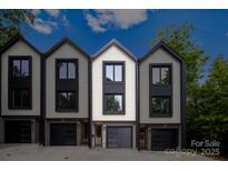 Modern townhome exterior featuring a private garage and neutral color palette for sophisticated curb appeal at 158 Mattoon St, Charlotte, NC 28216