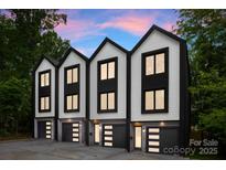 Modern townhomes with a sleek black and white color scheme and eye-catching garage doors at 158 Mattoon St, Charlotte, NC 28216
