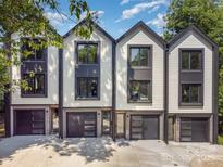 Charming townhomes featuring a modern design, private garages, and sleek black and white accents at 158 Mattoon St, Charlotte, NC 28216