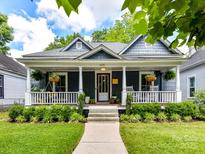 Charming home featuring a welcoming porch, lush landscaping, and classic architectural details at 1605 Allen St, Charlotte, NC 28205