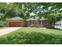 Charming brick home with a well-manicured lawn and a two-car garage, perfect for curb appeal at 16433 Grapperhall Dr, Huntersville, NC 28078