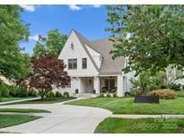 Charming white brick home with a manicured lawn and a curved driveway at 236 Wales Ave, Charlotte, NC 28209