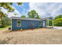 Charming blue home with a landscaped yard and a welcoming front porch at 251 Hall Spencer Rd, Catawba, SC 29704