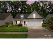 Charming single-Gathering home featuring a two-car garage, manicured lawn, and mature trees at 422 Drake Ln, Salisbury, NC 28146
