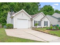 Charming single-story home with an attached garage, well-maintained lawn, and mature trees at 4719 Sahalee Ln, Charlotte, NC 28216