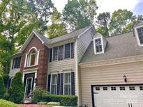 Charming two-story home with a combination of brick and siding, complemented by professionally landscaped front yard at 4846 Deer Cross Trl, Charlotte, NC 28269