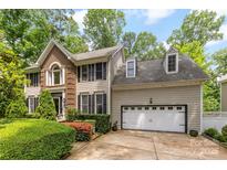 Charming two-story home featuring a brick accent wall, attached two car garage and beautifully manicured landscaping at 4846 Deer Cross Trl, Charlotte, NC 28269