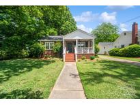 Charming brick home featuring a covered front porch and well-maintained landscaping, perfect curb appeal at 512 Forest Ln, Rock Hill, SC 29730