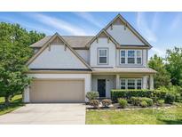 Charming two-story home with a well-maintained lawn and an attached two-car garage at 7166 Dove Field Ln, Fort Mill, SC 29707