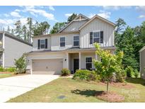 Charming two-story home features a well-manicured lawn and an attached two-car garage at 941 Rachel Anne Dr, Belmont, NC 28012