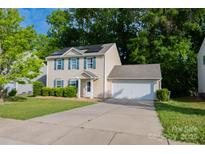 Charming two-story home with a two car garage, solar panels, and a well-manicured front lawn at 1518 Glenbar Ct, Clover, SC 29710