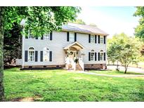 Charming two-story home with grey siding, black shutters, and a well-manicured lawn at 1575 Lewis Farm Rd, Kings Mountain, NC 28086