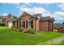 Charming brick home featuring a landscaped yard and classic black shutters at 1909 Wexford Ct, Gastonia, NC 28054