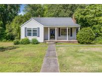 Charming single-story home with white siding, inviting front porch and well-maintained front lawn at 204 Blanche Ave, Belmont, NC 28012