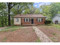 Charming brick home with black shutters and a cozy front porch at 2214 Grimes St, Charlotte, NC 28206