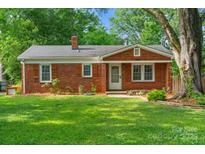 Charming brick home with a well-maintained lawn and mature trees in a desirable neighborhood at 2953 Enfield Rd, Charlotte, NC 28205