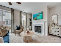 Cozy living room with fireplace, modern furniture, and view to outdoor patio at 308 Catawba Ave, Davidson, NC 28036
