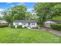 Charming one-story home featuring a well-manicured lawn and tidy landscaping at 3809 Topsfield Rd, Charlotte, NC 28211