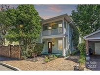 Charming two-story home with inviting front porch, lovely brickwork, and mature trees at 402 W 8Th St, Charlotte, NC 28202