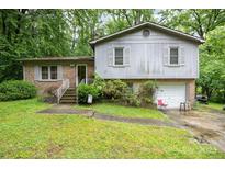 Split level home with a brick and gray wood facade and attached one car garage at 610 N Shaver St # 14, Salisbury, NC 28144