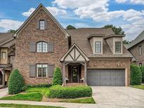 Beautiful brick home with a manicured lawn, covered entry and a two-car garage at 6128 Fletcher Cir, Charlotte, NC 28226