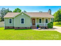 Charming single-story home featuring a cozy front porch, landscaped yard, and a well-maintained lawn at 752 Chipmeadow Ln, York, SC 29745