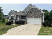 Charming home featuring stone accents, a two-car garage, and a well-maintained front lawn at 120 Autumn Mist Rd, Statesville, NC 28677
