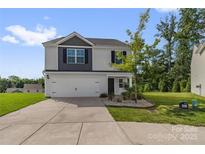 Charming two-story home with a well-manicured lawn and a two car garage at 155 Trail Wood Ct, Salisbury, NC 28146
