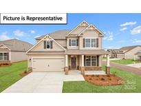 Charming two-story home with a two-car garage and beautiful landscaping at 160 Asmodean Ln, Troutman, NC 28166