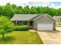 Charming single-story home with a manicured lawn, two-car garage, and inviting front porch at 2027 Ellison Dr, Rock Hill, SC 29730