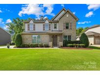 Charming two-story home with a well-manicured lawn, beautiful landscaping, and inviting front entrance at 3918 Halcyon Dr, Huntersville, NC 28078