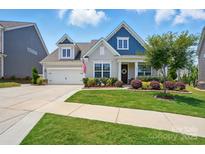 Charming single-Gathering home featuring a manicured lawn and beautiful landscaping with a two-car garage at 4527 Waylon Ave, Fort Mill, SC 29715