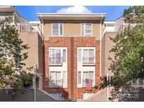 A charming brick townhouse with multi-level balconies on a sunny day at 511 Donatello Ave, Charlotte, NC 28205