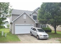 Charming two-story home with a two-car garage and well-maintained lawn and landscaping at 6105 Follow The Trl, Indian Trail, NC 28079