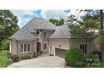 Beautiful brick and stone home featuring a two car garage and a well manicured lawn at 6132 Sharon Rd, Charlotte, NC 28210