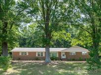 Charming brick ranch home with mature trees providing ample shade in the front yard at 160 Eagle Dr, Salisbury, NC 28144