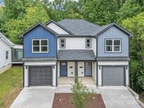 Charming townhouse featuring two-car garages, craftsman-style accents, and a well-manicured front yard at 1935 St Mark St, Charlotte, NC 28216