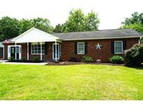 Charming brick home with well-maintained lawn, welcoming entrance, and patriotic decor at 1958 19Th Avenue Ne Dr # 8, Hickory, NC 28601