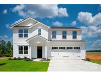 Beautiful two-story home with a crisp white facade, attached two car garage, and manicured lawn at 217 Basildon St # 1018, Lancaster, SC 29720