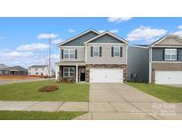 Charming two-story home with a well-maintained lawn and a two-car garage at 2605 Goose Fair Rd, Maiden, NC 28650