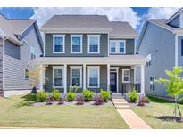 Charming two-story home with a covered front porch and manicured lawn at 3101 Virginia Trail Ct, Fort Mill, SC 29715