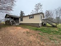 Charming exterior view of a single-story home with an inviting wooden porch and staircase at 3103 Blue Ridge Dr, Shelby, NC 28150