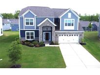 Charming two-story home with a manicured lawn, stone accents, and an attached two-car garage at 3719 Wave Rock Ct, Fort Mill, SC 29707