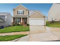 Charming two-story home with a well-manicured lawn and inviting front porch area at 3985 Village Nw Blvd, Conover, NC 28613
