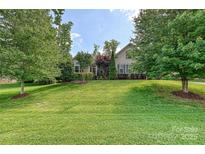 Charming single-story home with lush landscaping and a well-manicured lawn at 4018 Harmattan Dr, Denver, NC 28037