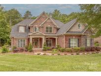 Beautiful brick home with a well-manicured lawn and tasteful landscaping. Traditional home design at 4113 Hoffmeister Dr, Waxhaw, NC 28173