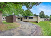 Charming single-story home with a brick accent wall and a covered carport at 467 16Th Nw Ave, Hickory, NC 28601