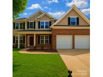 Charming two-story home with a well-manicured lawn and a two-car garage at 5607 Fulton Ridge Dr, Indian Trail, NC 28079