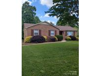Charming brick home with well-manicured landscaping and inviting curb appeal at 715 Gentry Pl, Charlotte, NC 28210