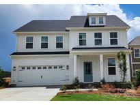 Two-story home featuring white siding, a blue front door, and an attached two-car garage at 885 Regulus Ct # 42, York, SC 29745